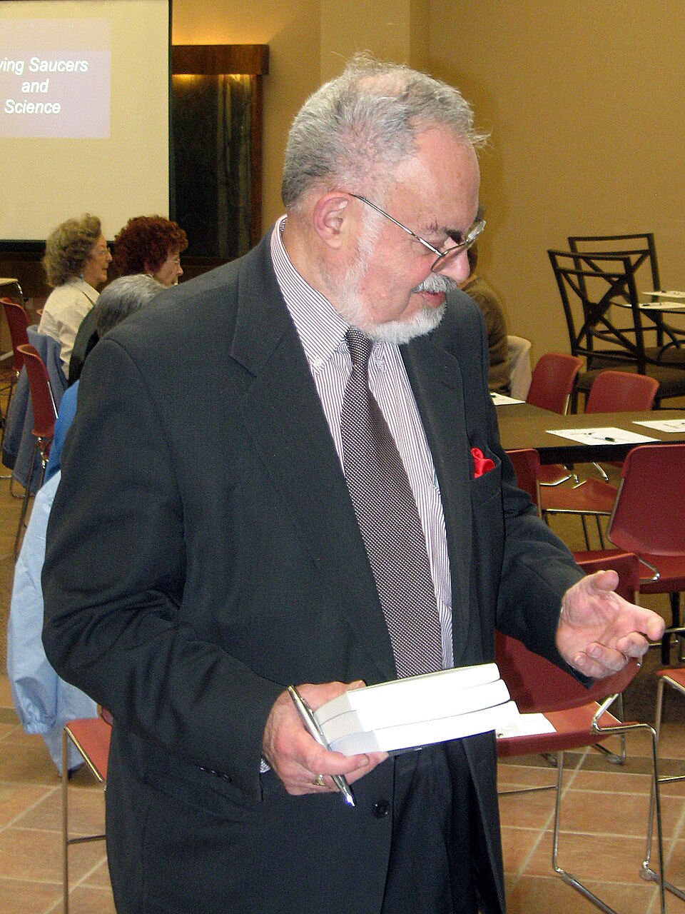 Stanton Friedman seated at a book-signing table in Alamogordo in 2010.