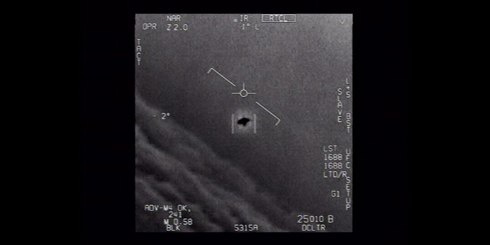 Full infrared display frame from the official U.S. Navy Gimbal video, letterboxed in a wide image, with targeting symbology surrounding a dark oblong heat signature above clouds.